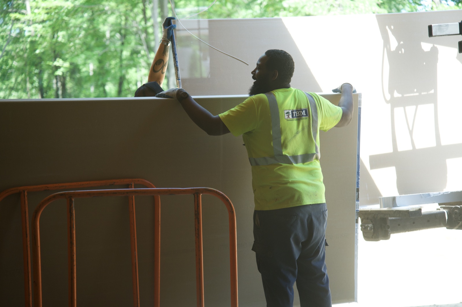 Unloading drywall in the garage bay
