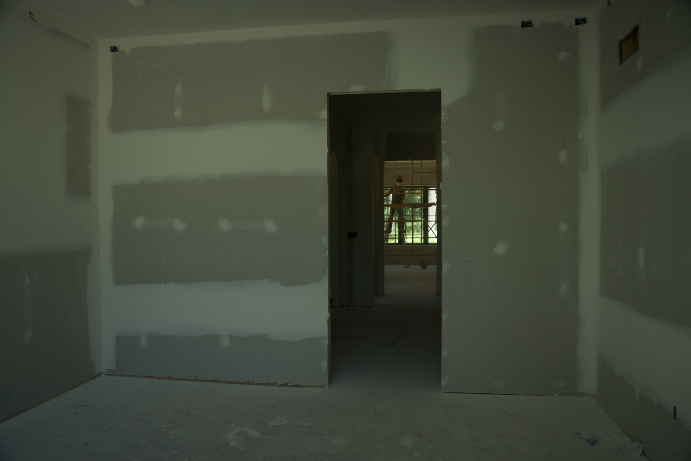 Freshly finished drywall walls in a room under construction